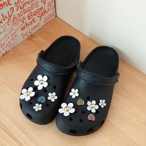 Crocs black daisy clogs